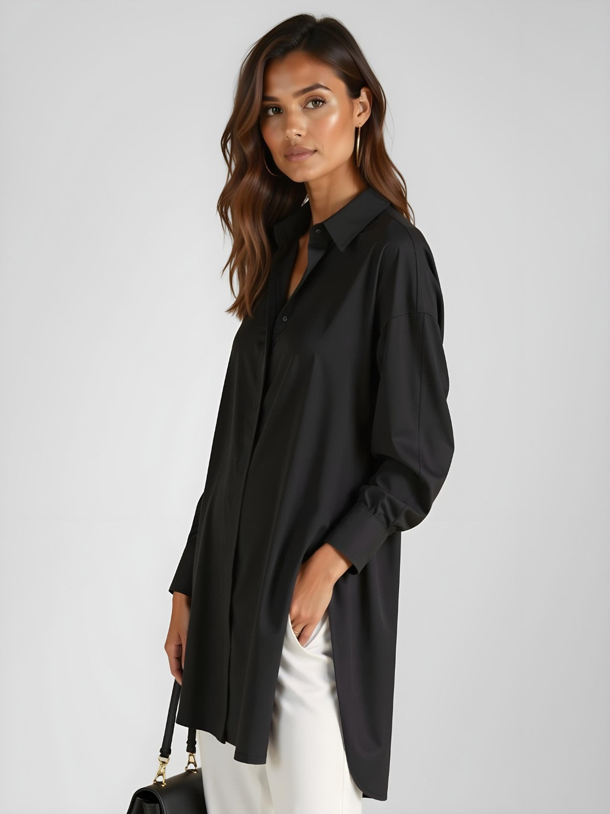 Woman wearing a black buttoned long shirt dress, standing and facing forward to show the fit and style.