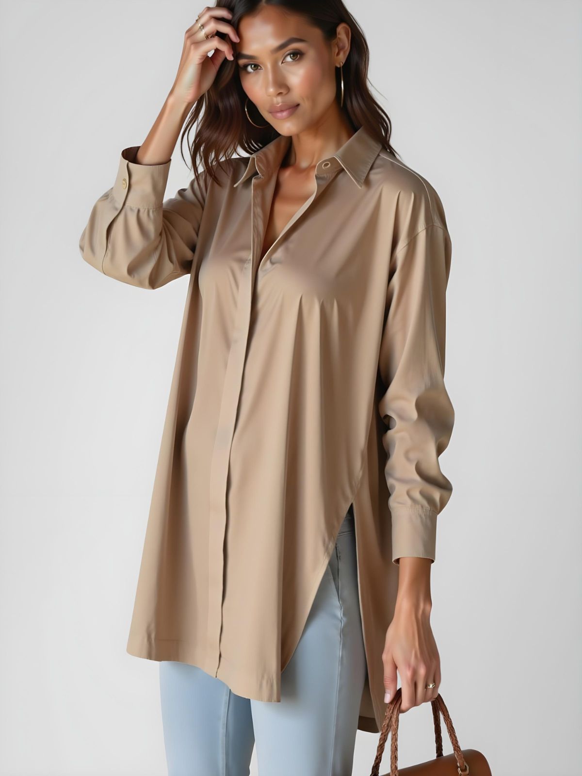Woman wearing a beige buttoned long shirt dress, standing and facing forward to show the fit and style.